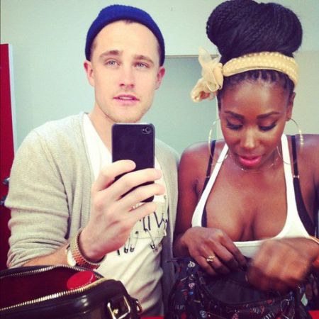 mirror selfie taken by bria myles current boyfriend while she is checking her purse.
